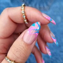 A set of nails with wavy pink and blue art. Barbiecore and mermaid nails are already looking to...