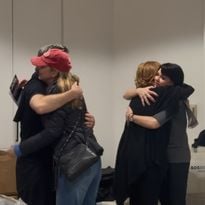 Grateful beauty pros impacted by the California wildfires hug volunteers passing our relief kits. - PBA